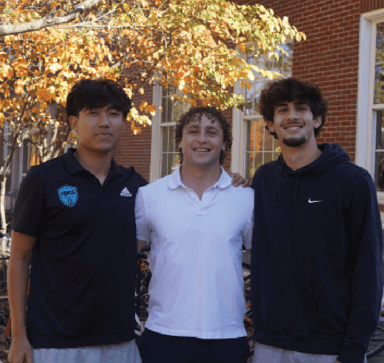 The ball flies down the field, a flash of white and black. In a perfectly coordinated fashion, the boys’ varsity soccer team moves the ball from player to player. Someone shoots for a goal, but it bounces off the goalpost, and the defense takes possession. Seniors Alex Sahinoglu, Finlay Fitch, and Aiden Xia, the captains, gather the team together, high-fiving and offering words of support and advice. This positive atmosphere is a result of weeks of sportsmanship, bonding, and dedication from the captains.